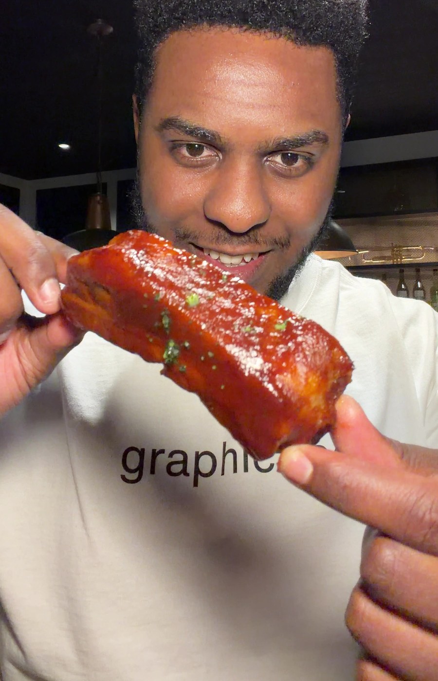 Zazi presenting a glazed rib at Boo's Bar